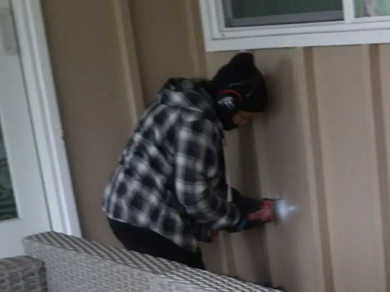 Professional electrician installing an exterior outlet in Oxford